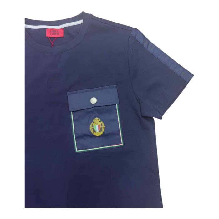 559 109 C rotated | The Enrico Coveri T-shirt with Button Pocket Logo in Navy combines a timeless design with modern functionality, making it a versatile staple for any wardrobe. Crafted from soft, breathable fabric, this T-shirt features a stylish buttoned chest pocket that not only adds a practical touch for storing small essentials but also enhances the overall aesthetic with its sleek design. The classic navy color, paired with Enrico Coveri's iconic logo subtly positioned near the pocket, ensures that this T-shirt delivers both comfort and sophistication, effortlessly transitioning from casual outings to more polished looks.