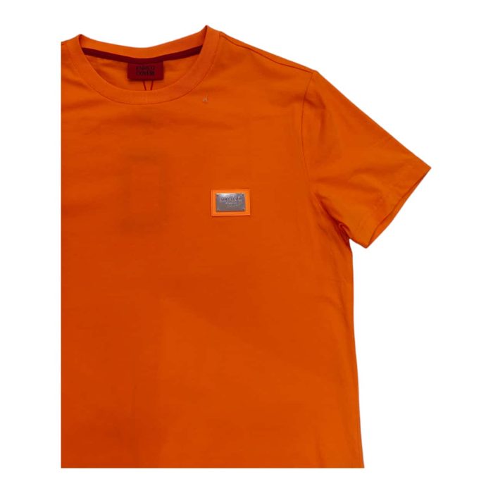 559 152 C | The Enrico Coveri Mini Metal Logo T-Shirt in Orange brings vibrant color and refined style together, crafted from high-quality cotton that feels soft and breathable for all-day comfort. Featuring a sleek mini metal logo on the chest, this T-shirt subtly highlights the brand's sophistication while enhancing its bold, standout orange shade, making it a versatile choice for casual and smart-casual looks alike. With a modern slim fit that flatters the body while allowing freedom of movement, this T-shirt perfectly captures Enrico Coveri’s dedication to both quality and contemporary Italian design.