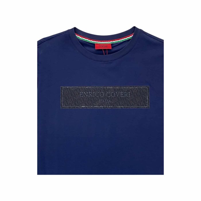 559 83B | The Enrico Coveri T-Shirt Italia Stud Logo in navy and black brings together classic Italian sophistication and a modern edge, featuring a bold black studded "Italia" logo that pops against the deep navy fabric. Made from soft, breathable cotton, this t-shirt provides a comfortable, relaxed fit with a timeless crew neck, making it perfect for both casual outings and stylish layering under a jacket. The versatile navy and black color combination, along with its durable, eye-catching design, make it a must-have addition to any wardrobe for those who appreciate refined yet bold style.