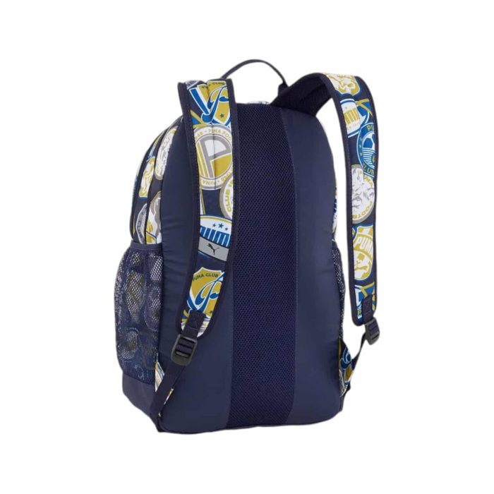 171 62 B | The Puma Backpack Academy Soccer Badges AOP Navy blends a sporty design with practicality, featuring a bold all-over print of soccer badges on a navy blue base, making it a perfect choice for soccer fans and active individuals. It offers a spacious main compartment with a padded laptop sleeve, a front zip pocket for quick-access items, and side mesh pockets for water bottles or snacks, ensuring you stay organized and prepared for any activity. Designed for comfort, this durable backpack also includes adjustable shoulder straps and a padded back panel, providing support and ease of carrying throughout your day.