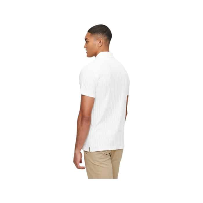 302 75 B | The Polo SS Textured Golfer in Off White offers a perfect blend of comfort, style, and versatility, crafted from a high-quality, breathable cotton blend that ensures all-day wearability. Its textured fabric adds a sophisticated touch to the classic polo design, while the off-white color provides a clean, modern look that can easily be paired with a variety of bottoms. The tailored fit, combined with a classic polo collar and short sleeves, makes this shirt a timeless addition to any wardrobe, ideal for both casual outings and more polished, smart-casual occasions.