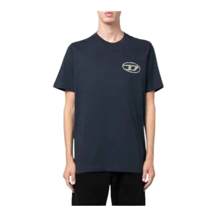 862 13 B | The Diesel T-Shirt T-Just Navy is a versatile wardrobe staple that combines premium comfort with timeless style. Crafted from soft, breathable cotton, it offers a perfect fit that ensures all-day wearability while maintaining its shape over time. With its rich navy color and subtle Diesel branding, this T-shirt can be easily dressed up or down, making it ideal for casual outings or layered for a more polished look.