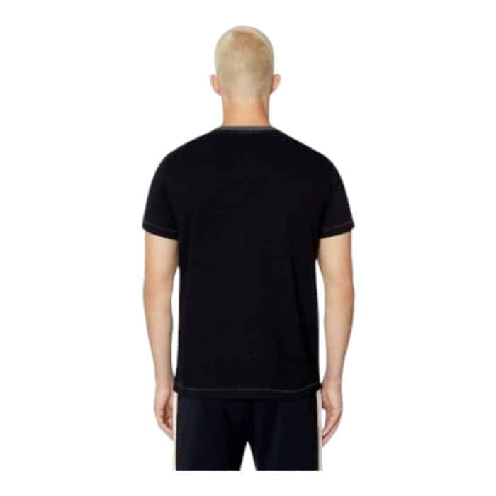 862 25 C | The Diesel T-Shirt T-Diegor E4 Black is a sleek and versatile wardrobe essential crafted from 100% premium cotton, offering a soft and breathable feel for all-day comfort. Its classic crew neckline and regular fit provide a universally flattering silhouette, while the minimalist design, complemented by the subtle Diesel logo on the chest, ensures effortless style for any occasion. Perfect for casual or semi-casual looks, this black T-shirt pairs easily with jeans, chinos, or shorts, making it a reliable foundation for various outfits year-round.