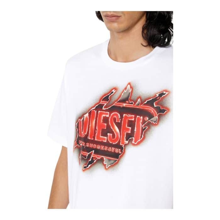 862 39 D | The Diesel T-Shirt T-Just E43 White combines bold graphic design with timeless versatility, making it a standout addition to any wardrobe. Crafted from 100% premium cotton, this T-shirt offers a lightweight, breathable feel and a regular fit for all-day comfort and effortless style. Featuring a striking front graphic against a crisp white backdrop, it transitions seamlessly from casual outings to trendy layered looks, embodying Diesel’s signature modern edge.