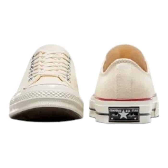 126 52 E | The Converse Chuck 70 Low OX in Parchment/Egret combines vintage-inspired design with modern craftsmanship, featuring a premium parchment canvas upper paired with a creamy egret midsole for a timeless, versatile look. Its durable construction includes reinforced stitching, a higher rubber foxing, and a cushioned OrthoLite insole, ensuring both style and all-day comfort. Subtle details like the textured rubber midsole and iconic All Star branding complete the design, making it a sophisticated choice for any wardrobe.