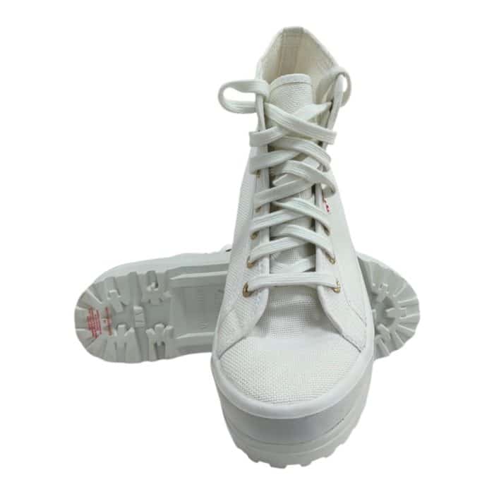 556 16 AC | The Superga HI Top 2341-Alpina White-Pale Gold combines timeless elegance with rugged functionality, featuring a breathable white canvas upper accented by subtle pale gold details for a refined, versatile look. Its high-top design offers enhanced ankle support, while the distinctive Alpina sole, inspired by mountaineering footwear, provides exceptional grip and durability across various terrains. Perfect for both casual and semi-formal occasions, this sneaker seamlessly blends style and practicality, making it a wardrobe essential for any season.