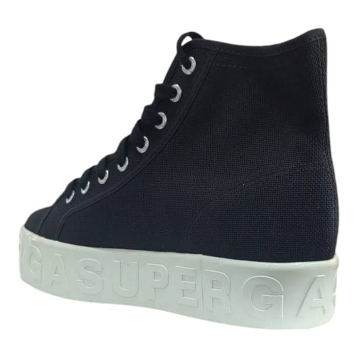 556 23 D | The Superga 2708 Shiny 3D Lettering Black combines sleek modern design with exceptional comfort, making it a standout choice for everyday wear. Featuring bold shiny 3D lettering against a timeless black canvas upper, these sneakers offer a perfect blend of understated elegance and contemporary edge. With a lightweight vulcanized rubber sole and durable construction, they provide all-day comfort and versatility, seamlessly complementing both casual and sporty outfits.