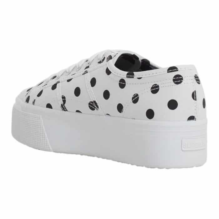 556 4 D | The Superga 2790 Polkadots White-Black combines playful charm with modern sophistication, featuring a bold black-and-white polka dot design that effortlessly elevates casual and chic outfits alike. Its 1.5-inch platform sole adds a subtle height boost while providing comfort and stability, making it perfect for all-day wear. Crafted with breathable cotton canvas and a durable rubber sole, this versatile sneaker ensures long-lasting style and functionality for any occasion.