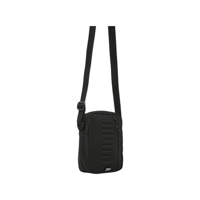 171 73B | The Puma S Portable Crossbody Bag Bold - Black is a sleek and durable everyday bag with an embossed Puma logo, adjustable strap, and multiple compartments for easy organization and versatile wear.