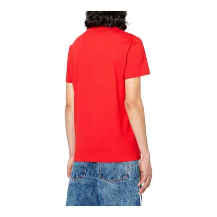 862 58 B | The Diesel T-Diegor K55 Red T-Shirt is a bold and stylish wardrobe essential, crafted from 100% premium cotton to ensure exceptional comfort, breathability, and durability for everyday wear. Featuring a vibrant red hue that exudes confidence, this slim-fit T-shirt is designed with a classic crew neck and short sleeves, making it a versatile piece that pairs effortlessly with jeans, joggers, or layered under a jacket for a more polished look. Accentuated with a subtle yet iconic Diesel logo on the chest, this T-shirt perfectly blends modern streetwear aesthetics with high-quality craftsmanship, offering a sleek and fashion-forward appeal for those who appreciate effortless style.