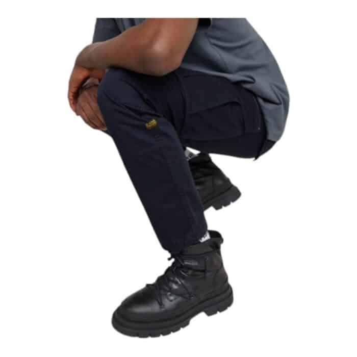 251 18 C | The G-Star Rovic Zip 3D Regular Tapered Cargo Pants in Salute Navy combine rugged military-inspired elements with a modern, streetwear-ready fit, featuring deep thigh pockets, articulated knees, and zip detailing for both practicality and a bold aesthetic. Made from a durable cotton blend with a slight stretch, these pants provide exceptional comfort, breathability, and freedom of movement, making them ideal for both casual wear and active lifestyles. With their tapered silhouette, adjustable hems, and reinforced stitching, these cargo pants offer a stylish yet functional option for those who appreciate utility-driven fashion without compromising on design.