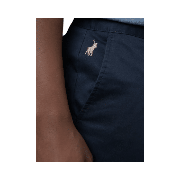 307 22D | The Polo Men's Chino Essential in navy offers a perfect blend of comfort and style. Made from a high-quality mix of 95% cotton and 5% spandex, these chinos feature a relaxed fit that ensures ease of movement. Designed with belt loops, a zip fly with button fastening, and functional pockets, they provide both practicality and sophistication. The classic navy color makes them versatile for any occasion, whether dressing up or down. Elevate your wardrobe with this timeless and functional chino.