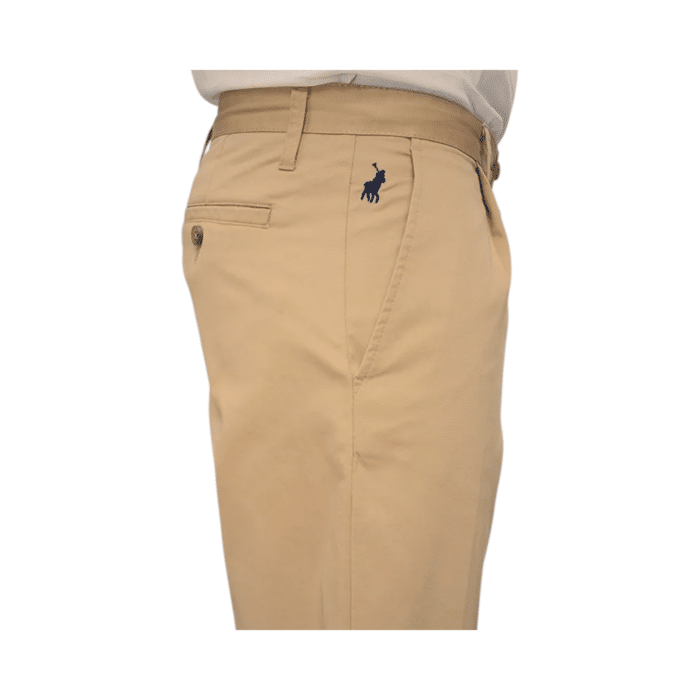 307 23A | The Polo Men's Chino Essential in khaki offers a perfect blend of comfort and style. Made from a high-quality mix of 95% cotton and 5% spandex, these chinos feature a relaxed fit that ensures ease of movement. Designed with belt loops, a zip fly with button fastening, and functional pockets, they provide both practicality and sophistication. The classic khaki color makes them versatile for any occasion, whether dressing up or down. Elevate your wardrobe with this timeless and functional chino.