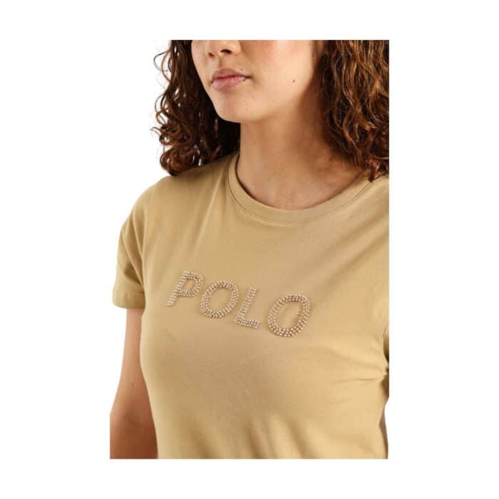 1004 4 C 1 | The Polo T-Shirt Lily Beaded Stone combines timeless style with a touch of elegance, featuring intricate bead and stone embellishments that add a subtle yet striking detail to its classic design. Crafted from premium, breathable fabric, this polo ensures comfort and durability, maintaining its shape and vibrant color even after multiple washes. Perfectly tailored to flatter all body types, it offers a modern, fitted silhouette that pairs effortlessly with jeans, trousers, or skirts, making it a versatile addition to any wardrobe for both casual and semi-formal occasions.