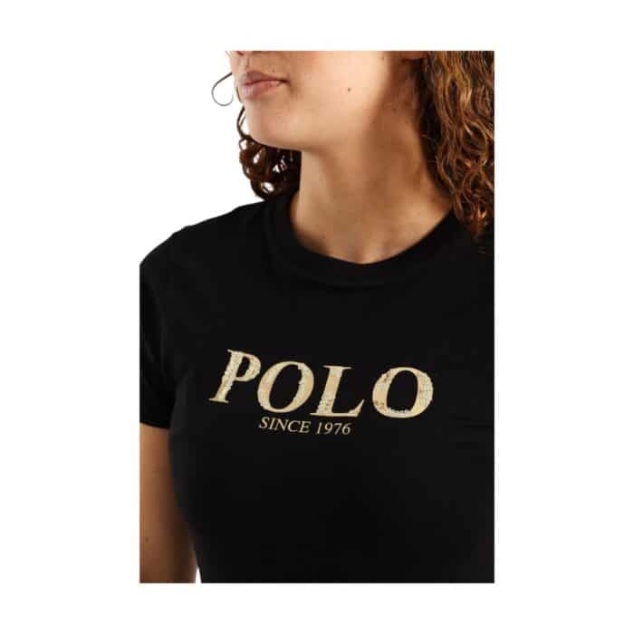 1004 7 B | The Polo T-shirt Ash Logo Black is a stylish and versatile wardrobe essential, crafted from premium-quality cotton that ensures breathability, durability, and all-day comfort while maintaining a sleek and polished look. Featuring a timeless black color with a subtle ash-colored logo, this polo shirt offers a modern yet classic appeal, complemented by a ribbed collar, well-structured cuffs, and a two-button placket for effortless styling across various occasions, from casual outings to semi-formal gatherings. Designed for both fashion and function, this moisture-wicking and shape-retaining polo pairs seamlessly with jeans, chinos, or layered ensembles, making it an indispensable addition to any wardrobe.