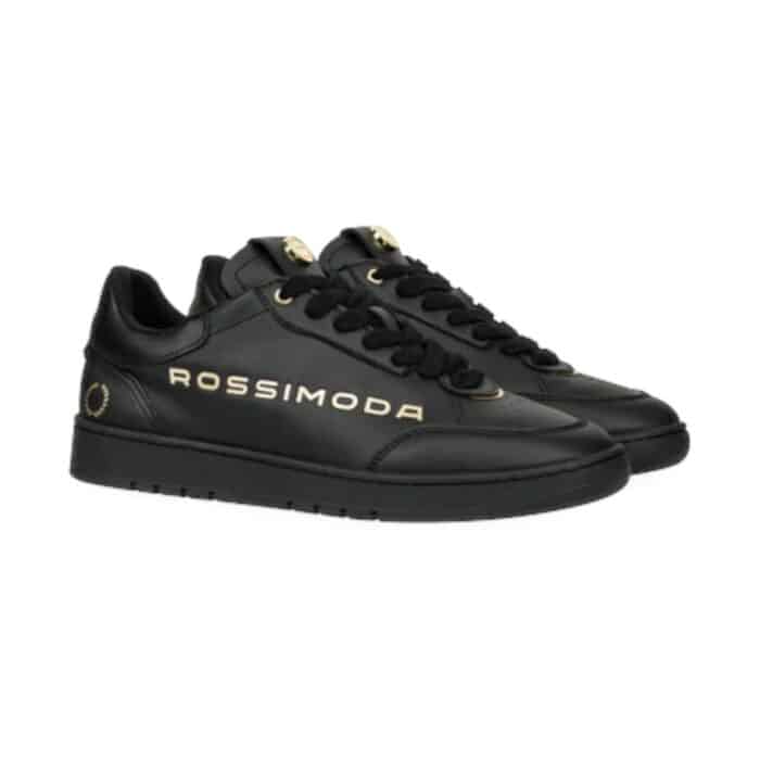 137 202 A | The Rossimoda Valentino BG Sneaker Black/Gold is a luxurious blend of elegance and contemporary streetwear, featuring a sleek black leather upper accented with opulent gold details that exude sophistication and status. Designed for both comfort and durability, this sneaker boasts a cushioned insole, premium inner lining, and a sturdy rubber outsole that provides excellent traction, ensuring all-day wearability without compromising on style. Whether paired with casual attire or more refined ensembles, its versatile silhouette and high-end craftsmanship make it the perfect statement piece for those who appreciate fashion-forward luxury.