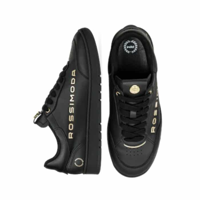 137 202 B | The Rossimoda Valentino BG Sneaker Black/Gold is a luxurious blend of elegance and contemporary streetwear, featuring a sleek black leather upper accented with opulent gold details that exude sophistication and status. Designed for both comfort and durability, this sneaker boasts a cushioned insole, premium inner lining, and a sturdy rubber outsole that provides excellent traction, ensuring all-day wearability without compromising on style. Whether paired with casual attire or more refined ensembles, its versatile silhouette and high-end craftsmanship make it the perfect statement piece for those who appreciate fashion-forward luxury.