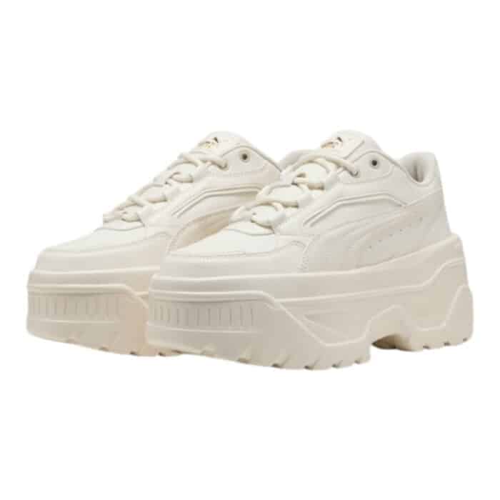 334 93 A | The Puma Karmen X-TRA in Frosted Ivory is a stylish yet functional sneaker that blends modern design with classic elements, featuring a premium leather upper complemented by synthetic overlays for durability and a sleek aesthetic. Its cushioned insole, padded collar, and lace-up closure ensure all-day comfort and a secure fit, while the platform rubber outsole provides excellent traction and a subtle height boost, making it ideal for both casual wear and urban adventures. Designed with versatility in mind, this minimalist sneaker seamlessly pairs with various outfits, offering a sophisticated touch to any wardrobe while aligning with Puma’s commitment to sustainability and high-quality craftsmanship.