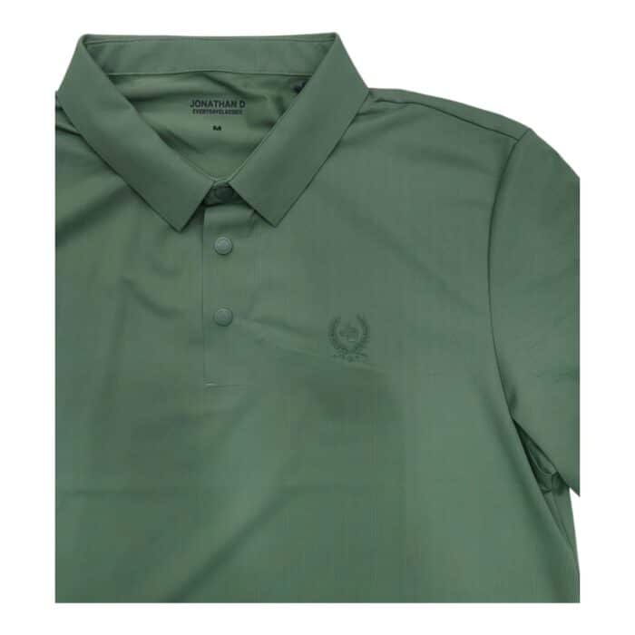 46 16 C rotated | The Jonathan D Golfer Luan Moss Green is a sophisticated and performance-driven golf shirt designed for players who seek both style and functionality, featuring a breathable, moisture-wicking fabric that keeps you cool and dry while ensuring maximum flexibility for an unrestricted swing. Crafted with precision stitching and a durable, high-quality material, this golfer shirt maintains its shape and softness even after multiple washes, while the refined collar and tailored fit provide a polished look that seamlessly transitions from the golf course to casual settings. With its rich Luan Moss Green shade that adds a natural, elegant touch, this versatile piece pairs effortlessly with various golf attire, allowing you to stand out subtly while enjoying premium comfort and top-tier performance