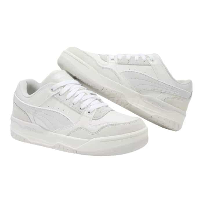 5 198 B | The Puma Rebound Retro SD White / Vapor Grey sneaker combines classic basketball-inspired design with modern comfort, featuring a high-quality leather upper that delivers durability and breathability, while the perforated side panels ensure optimal airflow for all-day wear. With its cushioned EVA foam midsole, this shoe offers superior comfort and support, making it ideal for both casual wear and light physical activities, providing a responsive feel with every step. The rubber outsole enhances grip and traction, ensuring stability on various surfaces, while the iconic Puma branding and retro silhouette add a timeless aesthetic that complements any casual outfit.