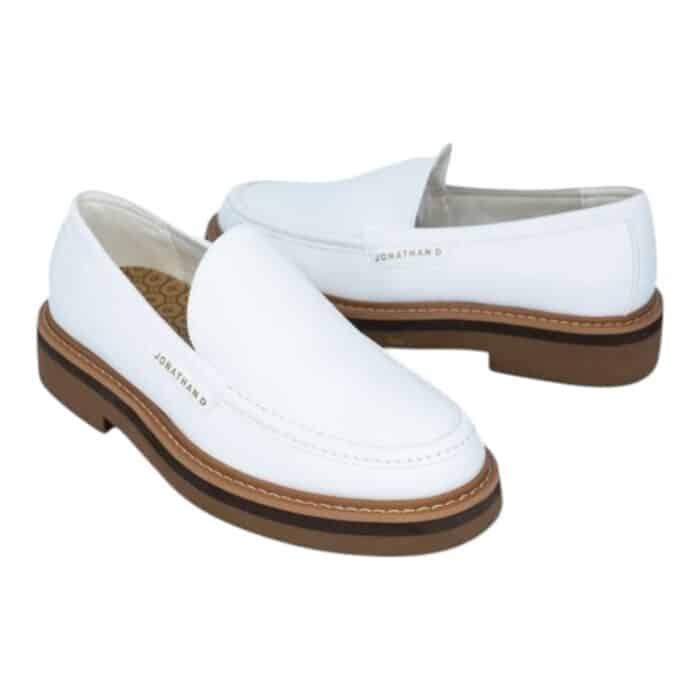 55 117 B | The Jonathan D Slip On Presley in White is a sleek and versatile footwear choice that combines modern minimalism with classic sophistication, making it perfect for both casual and semi-formal occasions. Crafted from high-quality materials, this slip-on shoe features a durable yet comfortable design with a soft upper that molds to the foot, a cushioned insole for all-day support, and a sturdy outsole that ensures excellent traction on various surfaces. Its crisp white color enhances its effortless elegance, while the absence of laces provides a clean, streamlined look that pairs seamlessly with anything from tailored trousers to relaxed denim.