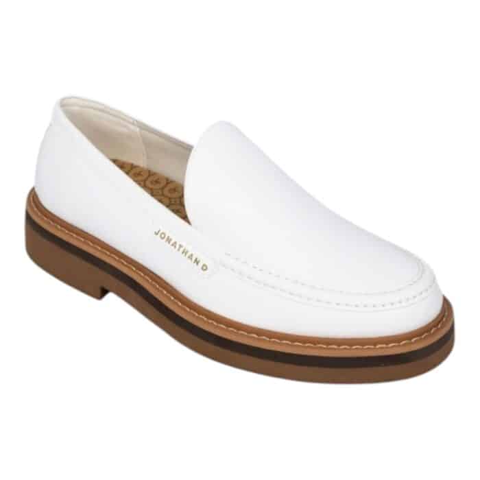 55 117 C | The Jonathan D Slip On Presley in White is a sleek and versatile footwear choice that combines modern minimalism with classic sophistication, making it perfect for both casual and semi-formal occasions. Crafted from high-quality materials, this slip-on shoe features a durable yet comfortable design with a soft upper that molds to the foot, a cushioned insole for all-day support, and a sturdy outsole that ensures excellent traction on various surfaces. Its crisp white color enhances its effortless elegance, while the absence of laces provides a clean, streamlined look that pairs seamlessly with anything from tailored trousers to relaxed denim.