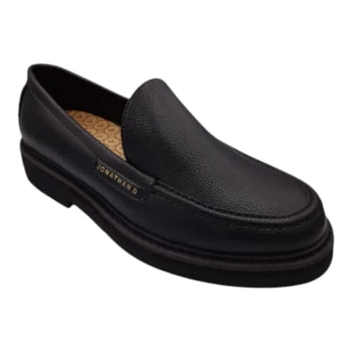 55 118 B | The Jonathan D Slip-On Persley Black is a sophisticated and versatile footwear choice, crafted with premium materials that ensure durability, comfort, and effortless style for any occasion. Designed with a sleek black finish, elastic side gussets for a secure fit, and a cushioned footbed for all-day support, this shoe seamlessly blends practicality with modern elegance, making it ideal for both formal and casual wear. Whether paired with tailored suits for business meetings or relaxed denim for weekend outings, the Persley Black offers a timeless aesthetic that enhances any wardrobe with its refined, minimalist appeal.