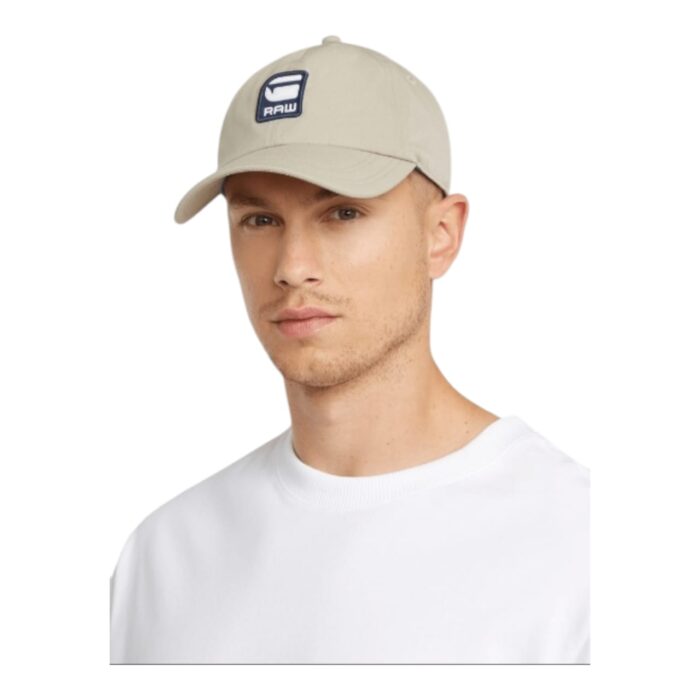 860 37 B | The G-Star Avernus Baseball Cap in Vintage Khaki is a stylish and functional accessory crafted from premium cotton twill, offering a perfect balance of durability, breathability, and all-day comfort, making it an ideal choice for casual outings and outdoor adventures. Designed with a classic six-panel structure, a curved brim for sun protection, and an adjustable strap with a branded metal buckle, this cap ensures a secure and personalized fit while maintaining a sleek, urban aesthetic that seamlessly complements various fashion styles. Featuring an embroidered G-Star Raw logo on the front, reinforced stitching for longevity, and an effortlessly versatile vintage khaki hue, this cap embodies timeless appeal and modern craftsmanship, making it a must-have addition to any wardrobe.